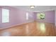 Spacious bedroom with wood floors and plenty of natural light from multiple windows at 1130 Burland Cir, Winter Garden, FL 34787