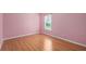 A well-lit bedroom featuring wood floors at 1130 Burland Cir, Winter Garden, FL 34787