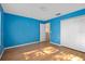 Cozy bedroom with blue walls, wood floors, closet, and interior door at 1130 Burland Cir, Winter Garden, FL 34787