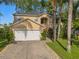 Well maintained two-story home featuring a two car garage, neutral paint, and well kept landscaping at 1130 Burland Cir, Winter Garden, FL 34787