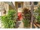 Home's red front door framed by lush plants and brick walkway leading to a cozy entrance at 1130 Burland Cir, Winter Garden, FL 34787