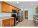 Modern kitchen featuring stainless steel appliances and wooden cabinetry at 1130 Burland Cir, Winter Garden, FL 34787
