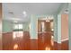 Open concept living room featuring shiny hardwood floors, sliding glass door to the backyard, and a neutral color palette at 1130 Burland Cir, Winter Garden, FL 34787