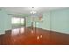 Spacious living room with hardwood floors and sliding glass door to a screened patio at 1130 Burland Cir, Winter Garden, FL 34787