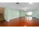 Open concept living room featuring hardwood floors and sliding glass door to the back yard at 1130 Burland Cir, Winter Garden, FL 34787