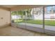 Covered patio enclosed with screens offering serene views of the green backyard at 1130 Burland Cir, Winter Garden, FL 34787