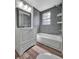 Bathroom featuring tiled shower-tub, modern vanity and hardware and hardwood-style floors at 1310 Coletta Dr, Orlando, FL 32807