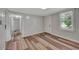 This bedroom features luxury vinyl plank floors, fresh paint, and a bright window at 1310 Coletta Dr, Orlando, FL 32807