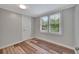 Cozy bedroom featuring wood floors and a view of the backyard at 1310 Coletta Dr, Orlando, FL 32807
