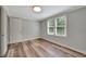 Well-lit bedroom features light walls, wood floors, ceiling light and bright window at 1310 Coletta Dr, Orlando, FL 32807