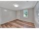 Cozy bedroom featuring wood-look floors, fresh paint and a bright window at 1310 Coletta Dr, Orlando, FL 32807