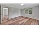 Bedroom with light gray walls, wood floors and access to a closet and open doorway at 1310 Coletta Dr, Orlando, FL 32807