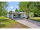 Charming single-story home with a covered carport and well-maintained front yard at 1310 Coletta Dr, Orlando, FL 32807