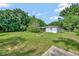 Quaint home on a large lot with a grassy yard surrounded by mature trees at 1310 Coletta Dr, Orlando, FL 32807