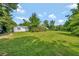 Spacious lot with lush lawn and mature trees around a cozy single Gathering home at 1310 Coletta Dr, Orlando, FL 32807
