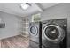Laundry room with front loading washer and dryer and extra shelving at 1310 Coletta Dr, Orlando, FL 32807