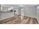 Open concept living room featuring durable wood flooring and views of the kitchen at 1310 Coletta Dr, Orlando, FL 32807