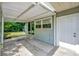 Covered back patio with cement flooring, door access, and view to backyard at 1310 Coletta Dr, Orlando, FL 32807