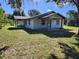 Charming single-story home featuring a covered porch, neutral siding, and a well-maintained lawn in a tranquil setting at 13208 Massachusetts Ave, Astatula, FL 34705