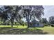 Quaint single story home with shade trees in front and beautiful landscaping in the front yard at 13208 Massachusetts Ave, Astatula, FL 34705