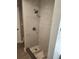 Modern shower features elegant marble-style tile, a sleek showerhead, and a tiled base, creating a spa-like atmosphere at 13208 Massachusetts Ave, Astatula, FL 34705