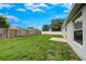 Expansive backyard with lush lawn, a concrete patio, and secure fencing for outdoor enjoyment at 1373 Burnley Ct, Kissimmee, FL 34758