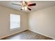 Bright bedroom with wood-look flooring, a window, and neutral paint offers a comfortable retreat at 1373 Burnley Ct, Kissimmee, FL 34758