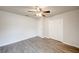 A clean bedroom with wood-look floors, a ceiling fan, and a closet provides comfort and style at 1373 Burnley Ct, Kissimmee, FL 34758