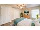 This bedroom boasts wood-look floors, a ceiling fan, and modern decor at 1373 Burnley Ct, Kissimmee, FL 34758