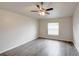Neutral bedroom offers natural light, ceiling fan, and wood-look flooring at 1373 Burnley Ct, Kissimmee, FL 34758