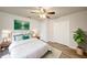 Bright bedroom with white bedding, wood-look floors, accent plant, and a ceiling fan at 1373 Burnley Ct, Kissimmee, FL 34758