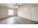 Spacious bedroom with wood floors, ceiling fan, and window at 1373 Burnley Ct, Kissimmee, FL 34758