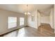 Elegant dining room with chandelier lighting and view into another room at 1373 Burnley Ct, Kissimmee, FL 34758