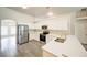 Bright kitchen with stainless steel appliances, white cabinets, and stylish flooring at 1373 Burnley Ct, Kissimmee, FL 34758