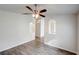 Bright living room featuring modern ceiling fan and stylish gray wood-look flooring at 1373 Burnley Ct, Kissimmee, FL 34758