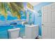 Bright bathroom featuring stylish beach themed decor, white vanity, and modern fixtures at 141 N Hill Ave # 141, Deland, FL 32724