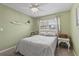 Bright bedroom with green walls, a ceiling fan, and a window view to the outside at 141 N Hill Ave # 141, Deland, FL 32724