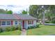 Charming single-story home with red trim, a well-manicured lawn, and a welcoming front entrance at 141 N Hill Ave # 141, Deland, FL 32724