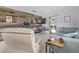 Cozy living room with tile floors, a decorative wood wall, and a comfortable blue sofa at 141 N Hill Ave # 141, Deland, FL 32724