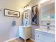 Bright bathroom with dual white vanities, mirrors, modern lighting, and framed wall art at 14529 Falling Tree Ct, Orlando, FL 32837