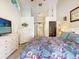 Bright bedroom with ceiling fan offers light walls and carpet, and a dresser with TV at 14529 Falling Tree Ct, Orlando, FL 32837