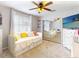 Bright bedroom features a daybed, mirrored closet, and a desk area, perfect for relaxation and productivity at 14529 Falling Tree Ct, Orlando, FL 32837