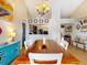 Open dining room with wooden table, modern chandelier, and adjacent kitchen area for seamless entertaining at 14529 Falling Tree Ct, Orlando, FL 32837