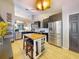 Spacious kitchen with a center island, stainless steel appliances, dark cabinetry, and an open design for modern living at 14529 Falling Tree Ct, Orlando, FL 32837