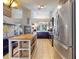 Bright kitchen featuring stainless steel appliances, a functional island with seating, and open access to other living areas at 14529 Falling Tree Ct, Orlando, FL 32837