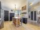Warm kitchen featuring an island, stainless steel appliances, black cabinets, and tile floors that enhance its charm at 14529 Falling Tree Ct, Orlando, FL 32837