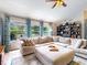 Bright living room with a large sectional sofa, display shelves, and a view of the backyard at 14529 Falling Tree Ct, Orlando, FL 32837