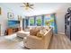 Inviting living room boasts a comfortable sectional, large windows, and ceiling fan for year-round comfort at 14529 Falling Tree Ct, Orlando, FL 32837