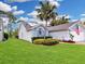 Lush green lawn surrounds this lovely home, beautifully landscaped with mature plantings, and a crisp paint job at 14529 Falling Tree Ct, Orlando, FL 32837