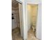 Open view of a bathroom with toilet and a walk-in closet featuring wire racks and poles at 1524 Crawford Dr, Apopka, FL 32703